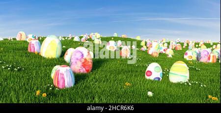 Many colorful easter eggs in the grass of a meadow for easter, copy space for individual text Stock Photo