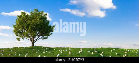 any colorful Easter eggs for Easter in the grass of a meadow around a tree Stock Photo