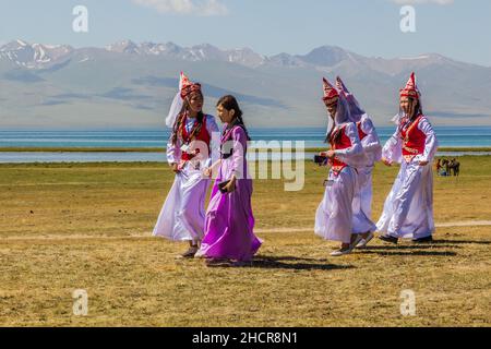 SONG KOL, KYRGYZSTAN - JULY 25, 2018: Traditional dress wearing girls during the National Horse Games Festival at the shores of Son Kol Lake Stock Photo