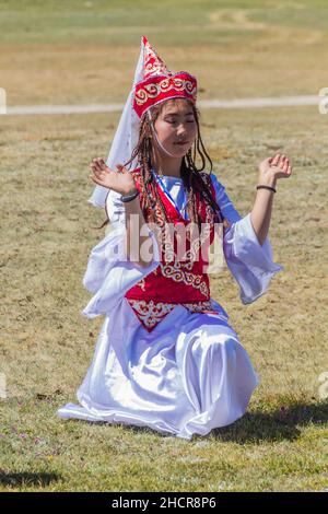 SONG KOL, KYRGYZSTAN - JULY 25, 2018: Traditional dress wearing girl during the National Horse Games Festival at the shores of Son Kol Lake Stock Photo