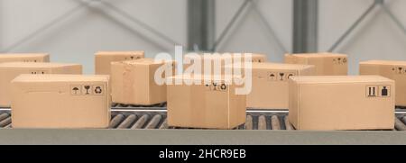 Packages delivery, packaging service and parcels, cardboard boxes on conveyor belt in warehouse, transportation system concept image Stock Photo