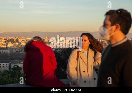 Rome, Italy. 31st Dec, 2021. Tourists observe city of Rome at sunset from Piazzale Garibaldi on Janiculum Hill, on December 31, 2021 (Photo by Matteo Nardone/Pacific Press) Credit: Pacific Press Media Production Corp./Alamy Live News Stock Photo