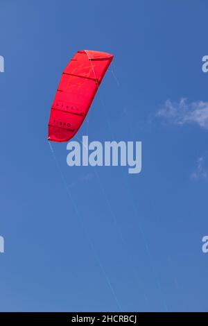 Red kite against a blue sky Stock Photo