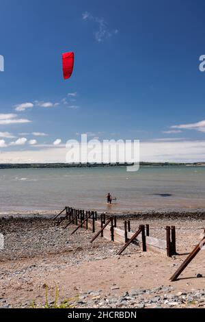 Kite surfer on the beach at Llanfairfechan, North Wales Stock Photo