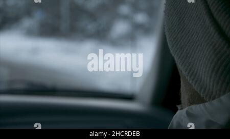 Car interior and winter road. Footage. Driver and passenger view from the cockpit of a car on the snowy road, back view p Stock Photo