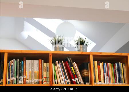 Bratislava, Slovakia - August 31, 2019: Last shelf with books in Slovak under the ceiling in the library of monastery Stock Photo