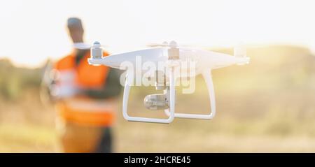 Drone operated by construction worker on building site Stock Photo