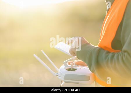 Drone operated by construction worker on building site use touchscreen Stock Photo