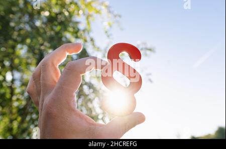 Close-up of a person's hand holding red paragraph symbol Stock Photo