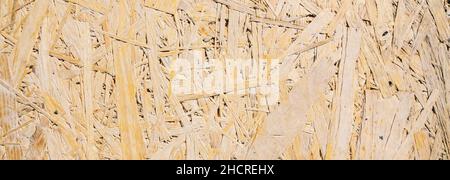 Sheet of plywood with fragments of compressed sawdust, banner size Stock Photo
