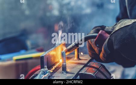 Industrial Worker welding the iron Stock Photo