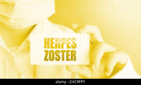 Doctor holding herpes zoster card in hands. Healthcare concept. Stock Photo