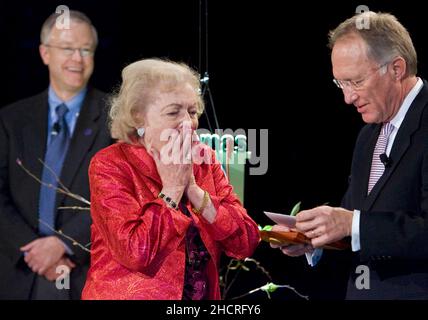 Kansas City, USA. 20th Jan, 2011. Actress Betty White reacts to Brad Moore, president of Hallmark Hall of Fame Productions, as he opens a birthday card for her at Crown Center in Kansas City, Missouri, on Thursday, January 20, 2011. Moore surprised White after the screening of her upcoming Hallmark Hall of Fame movie 'The Lost Valentine.' (Allison Long/Kansas City Star/MCT/Sipa USA) Credit: Sipa USA/Alamy Live News Stock Photo