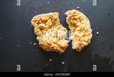 divided streusel bun or roll on old table Stock Photo