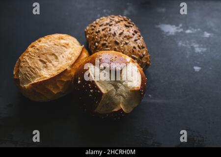 Different kinds of bread rolls on black board Stock Photo