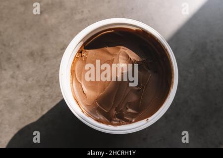 homemade hazelnut spread in plastic bowl. Hazelnut Nougat cream. Stock Photo