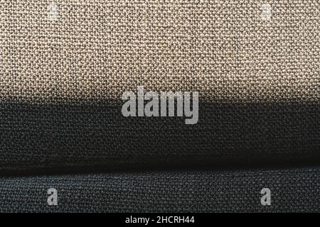 Close up wool pattern of a grey luxury sofa in the living room for background texture with shadow Stock Photo