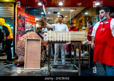A Young Man Prepares A Traditional Flat Bread To Put In An Oven, Abuzaghleh Restaurant, Downtown Amman, Amman, Jordan. Stock Photo