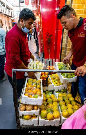 Two Young Men Delivering Fruit To A Restaurant In Downtown Amman, Amman, Jordan. Stock Photo