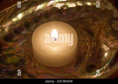 Abalone Seashell with a lit candle. Stock Image. Stock Photo