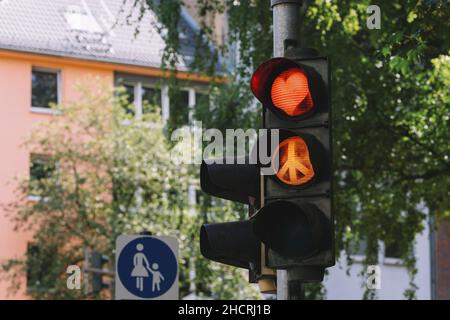 traffic light with red heart shape and Peace sign in the city Stock Photo