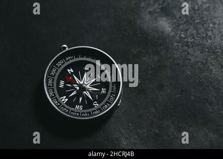 compass on a dark background concept for direction, travel, guidance or assistance Stock Photo