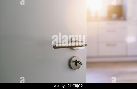 opened white door to modern kitchen interior as background Stock Photo