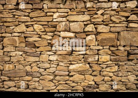 Wide Shot of Stacked Stone Wall with beige Rocks background image Stock Photo