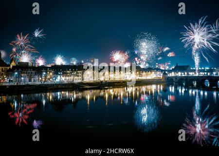 Maastricht celebrates the new year with an impressive fireworks display reflecting on the Maas river near Sint Servaasbrug - The Netherlands, Europe