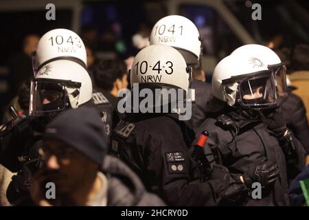 Duesseldorf, Germany. 01st Jan, 2022. Police officers in helmets guard the many revellers on New Year's Eve on the Rhine in Düsseldorf. Credit: David Young/dpa/Alamy Live News Stock Photo