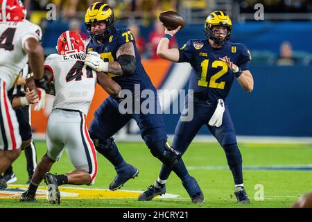 Florida, USA. 31st Dec, 2021. Michigan Wolverines quarterback Cade McNamara (12) throws the ball during the Capital One Orange Bowl NCAA College Football Playoff game between Georgia and Michigan on Friday December 31, 2021 at Hard Rock Stadium in Miami Gardens, FL. Jacob Kupferman/CSM Credit: Cal Sport Media/Alamy Live News Stock Photo