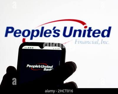 Ukraine. 31st Dec, 2021. In this photo illustration People's United Financial Bank logo seen displayed on a smartphone and in the background. Credit: SOPA Images Limited/Alamy Live News Stock Photo