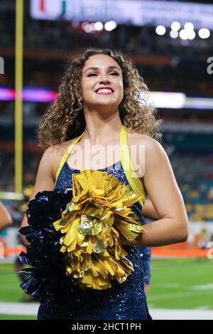 Florida, USA. 31st Dec, 2021. December 31, 2021: A Michigan cheerleaders cheers for her team during the 88th Capital One Orange Bowl at Hard Rock Stadium in Miami Gardens, Florida (Credit Image: © Cory Knowlton/ZUMA Press Wire) Credit: ZUMA Press, Inc./Alamy Live News Stock Photo