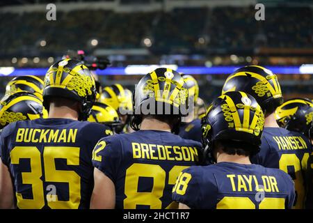 Florida, USA. 31st Dec, 2021. December 31, 2021: Michigan teammates huddle at warm ups during the 88th Capital One Orange Bowl at Hard Rock Stadium in Miami Gardens, Florida (Credit Image: © Cory Knowlton/ZUMA Press Wire) Credit: ZUMA Press, Inc./Alamy Live News Stock Photo