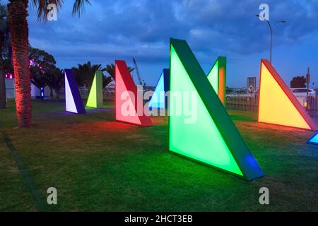 A group of colorful, triangular light sculptures in a park in Tauranga, New Zealand Stock Photo