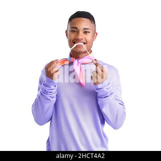 Young African-American guy in violet clothes and with chewing gum on white background Stock Photo