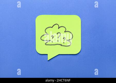 Sticky note with drawn cloud and question marks on blue background Stock Photo