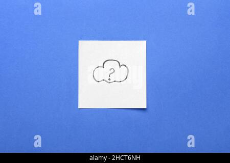 Sticky note with drawn cloud and question mark on blue background Stock Photo