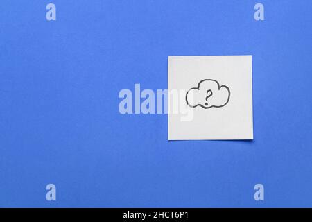 Sticky note with drawn cloud and question mark on blue background Stock Photo