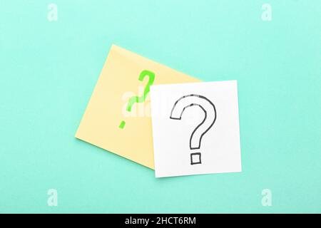 Sticky notes with question marks on blue background Stock Photo