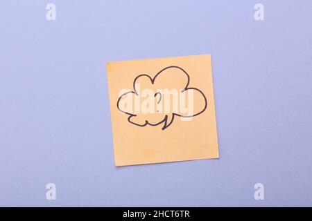 Sticky note with drawn speech bubble and question mark on grey background Stock Photo