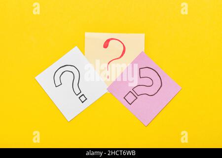 Sticky notes with question marks on yellow background Stock Photo