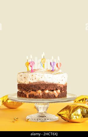 Stand with tasty birthday cake and balloons on pink background Stock ...