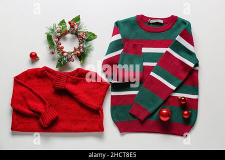 Stylish children's clothes and Christmas decor on white background Stock Photo