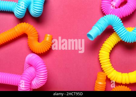 Different Pop Tubes on color background Stock Photo