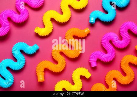 Different Pop Tubes on color background Stock Photo