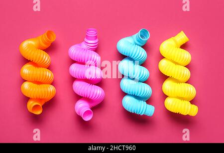 Different Pop Tubes on color background Stock Photo