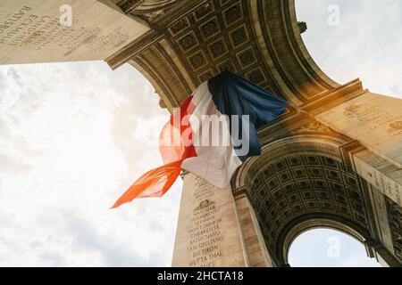 Arc de Triomphe with french flag during bastille day in paris, france Stock Photo