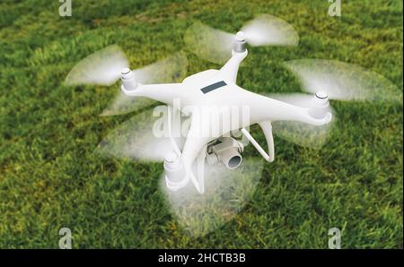 Drone with camera and black plaque over a green meadow Stock Photo