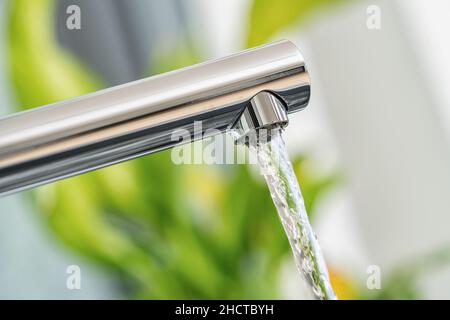 Open chrome faucet in the kitchen Stock Photo